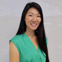 Dr. Dana Kang, smiling, with long dark hair, in a green sleeveless top